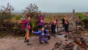 Group of women laughing during a break on the trail